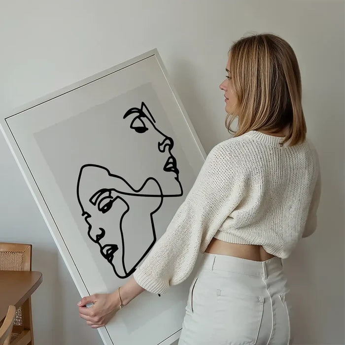 Two Faces Study Line Art Print held up against a living room wall