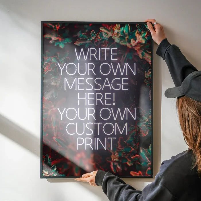 White Neon Centered Leaves Print being hung on a wall in a black frame