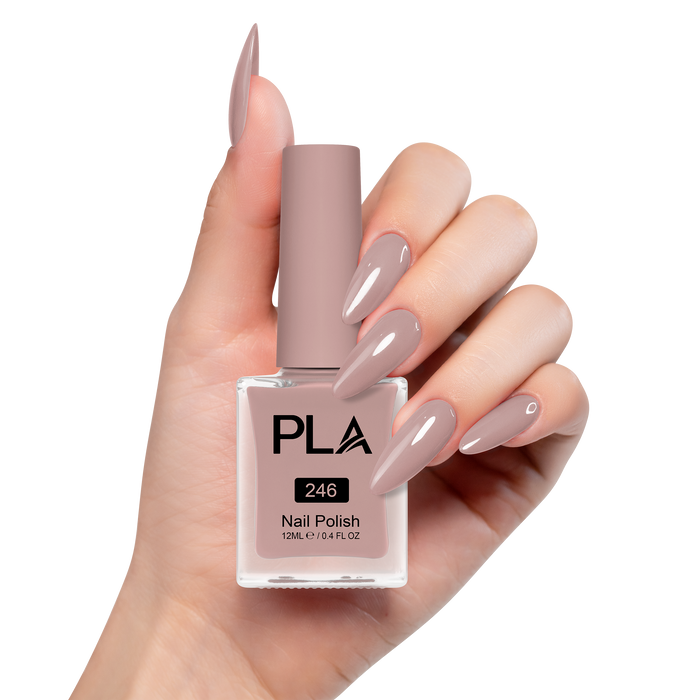 Hand holding a bottle of PLA nail polish with matching nails on a white background