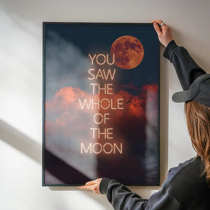 You Saw The Whole Of The Moon Lyrics Print being hung on a wall in a black frame