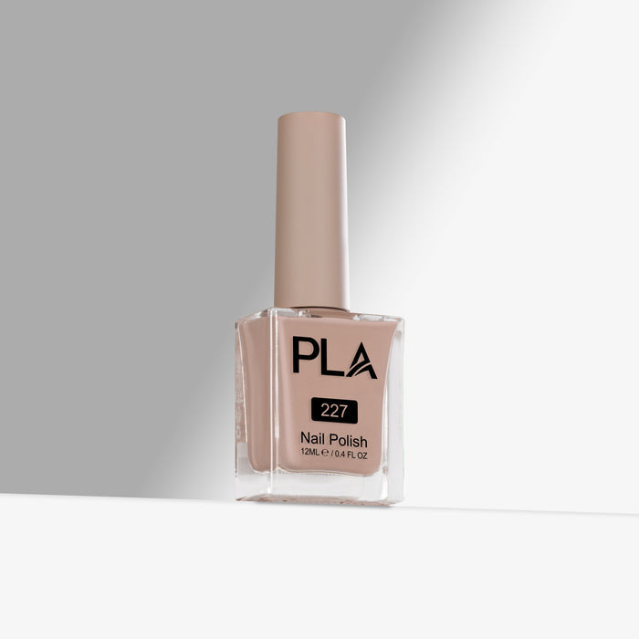 PLA nail polish bottle with beige polish on a gray background